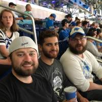 group of three men smiling at the football game